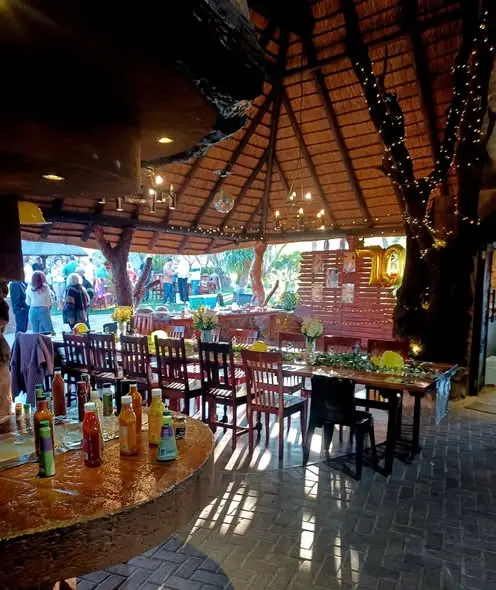 Long tables set in the thatched lapa